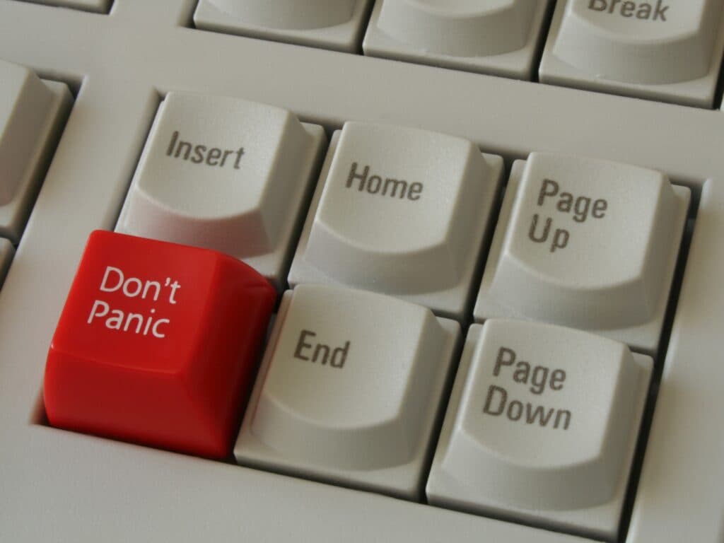 Closeup of computer keyboard with red panic button