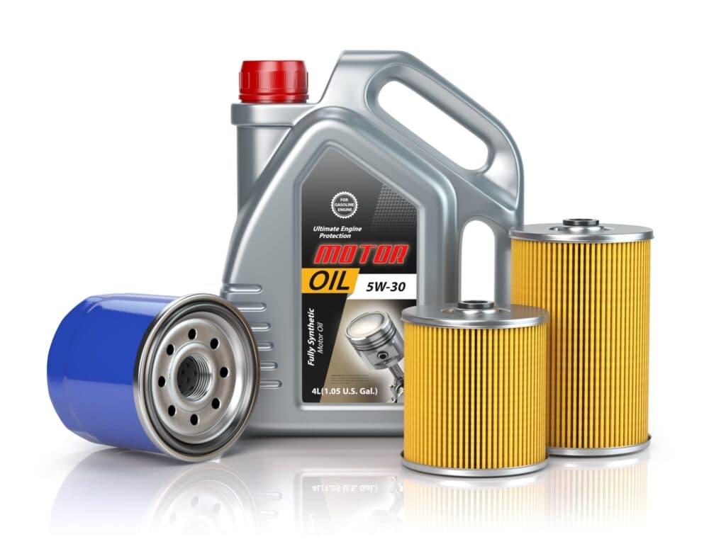 A jug of motor oil next to an oil filter and air filters.