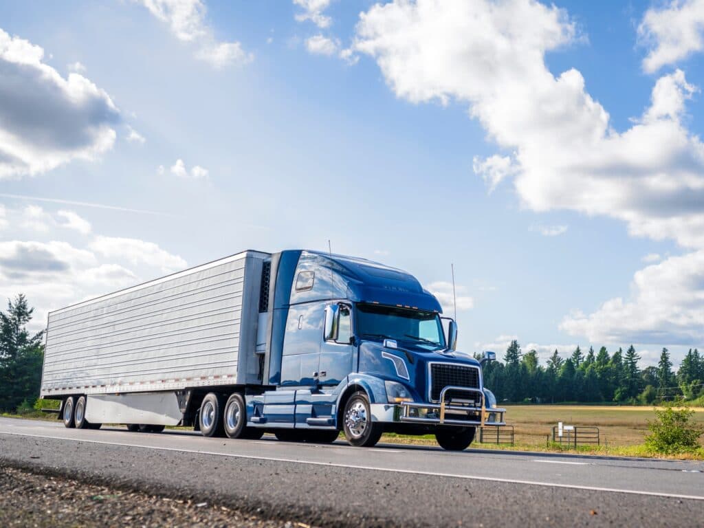 Blue cargo truck driving through the country