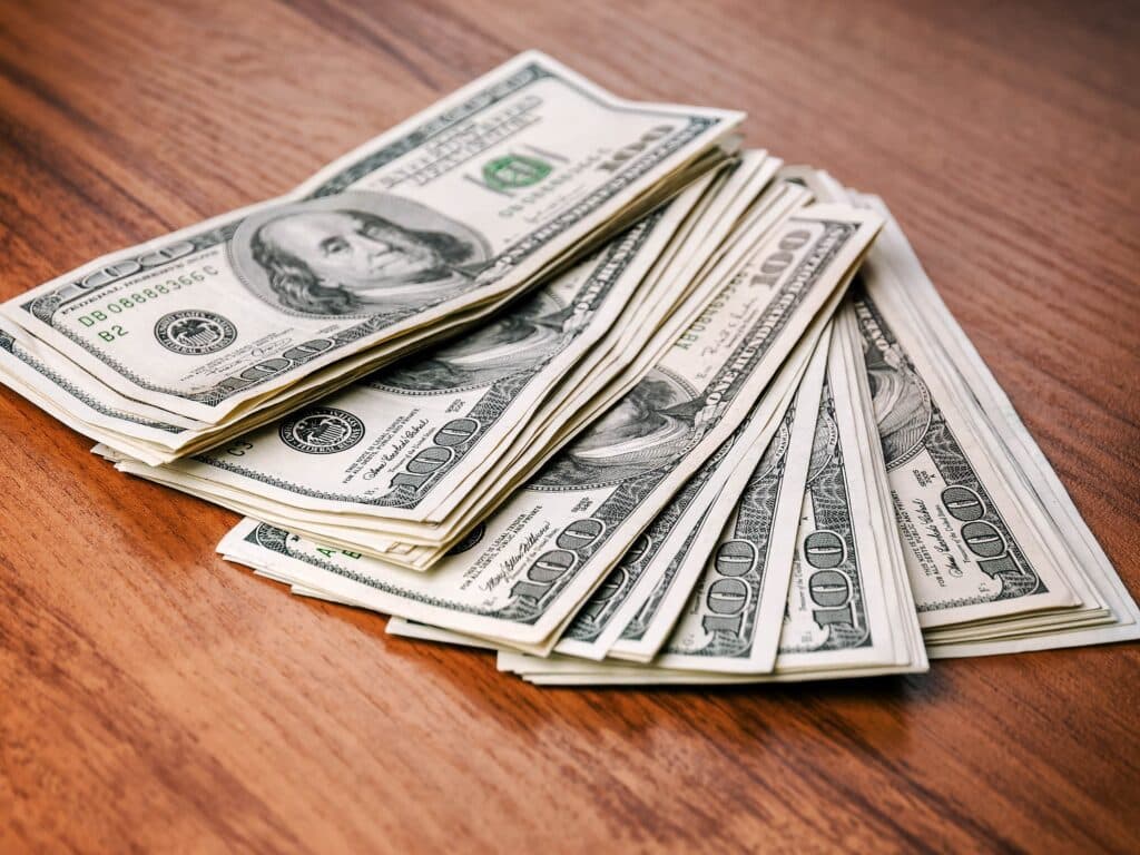 pile of money (dollars) on the table