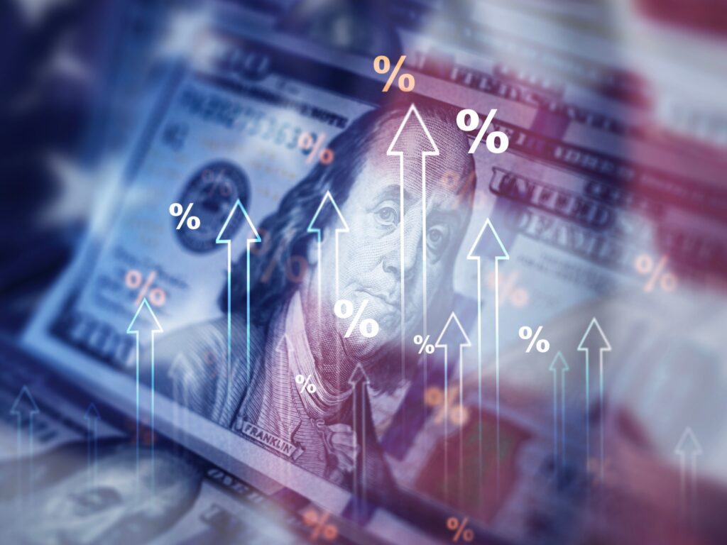 Picture of $100 bill with tariff rates climbing.